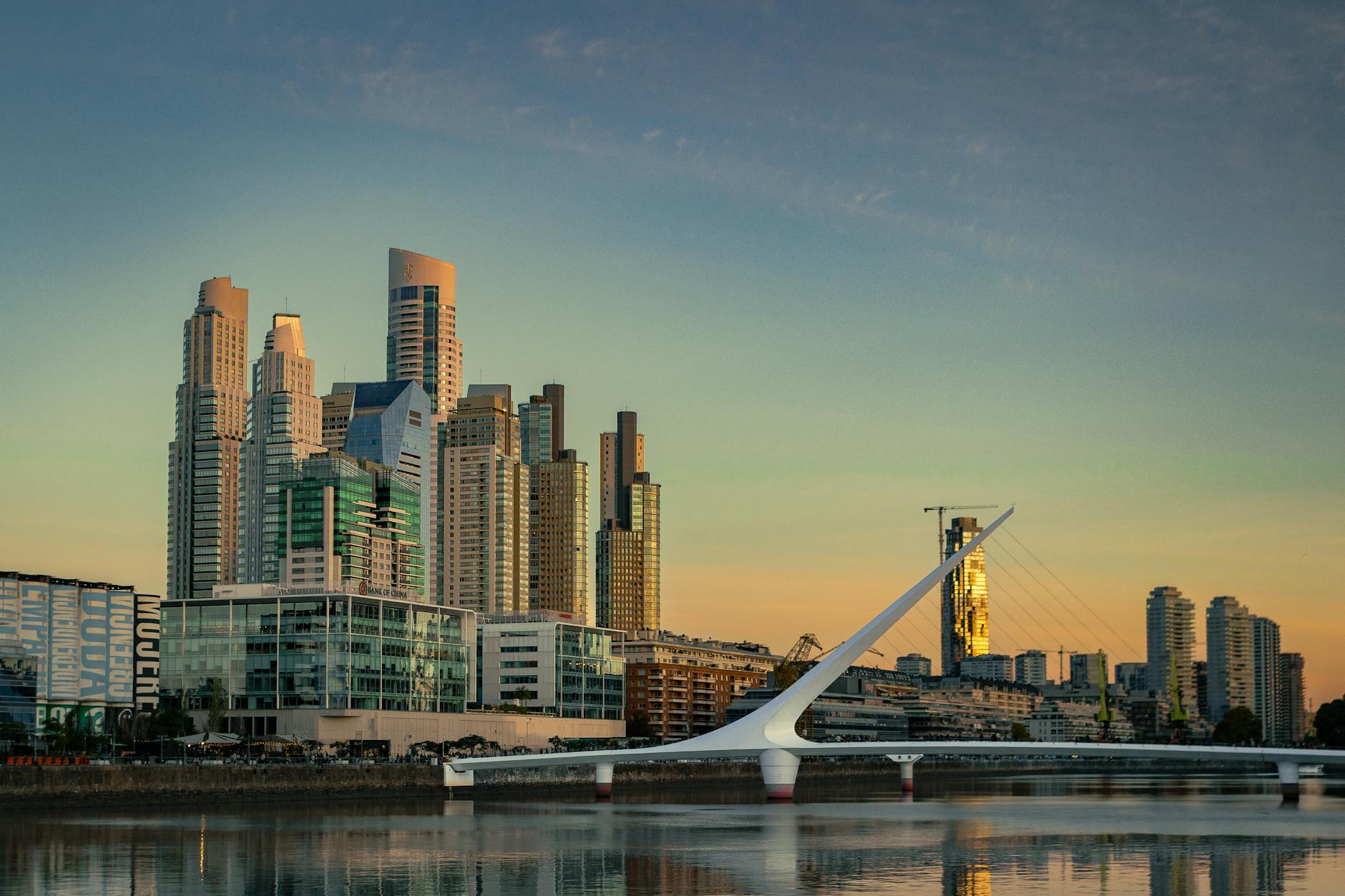 Modern Latin American city skyline at dusk with glass office towers and warm evening light