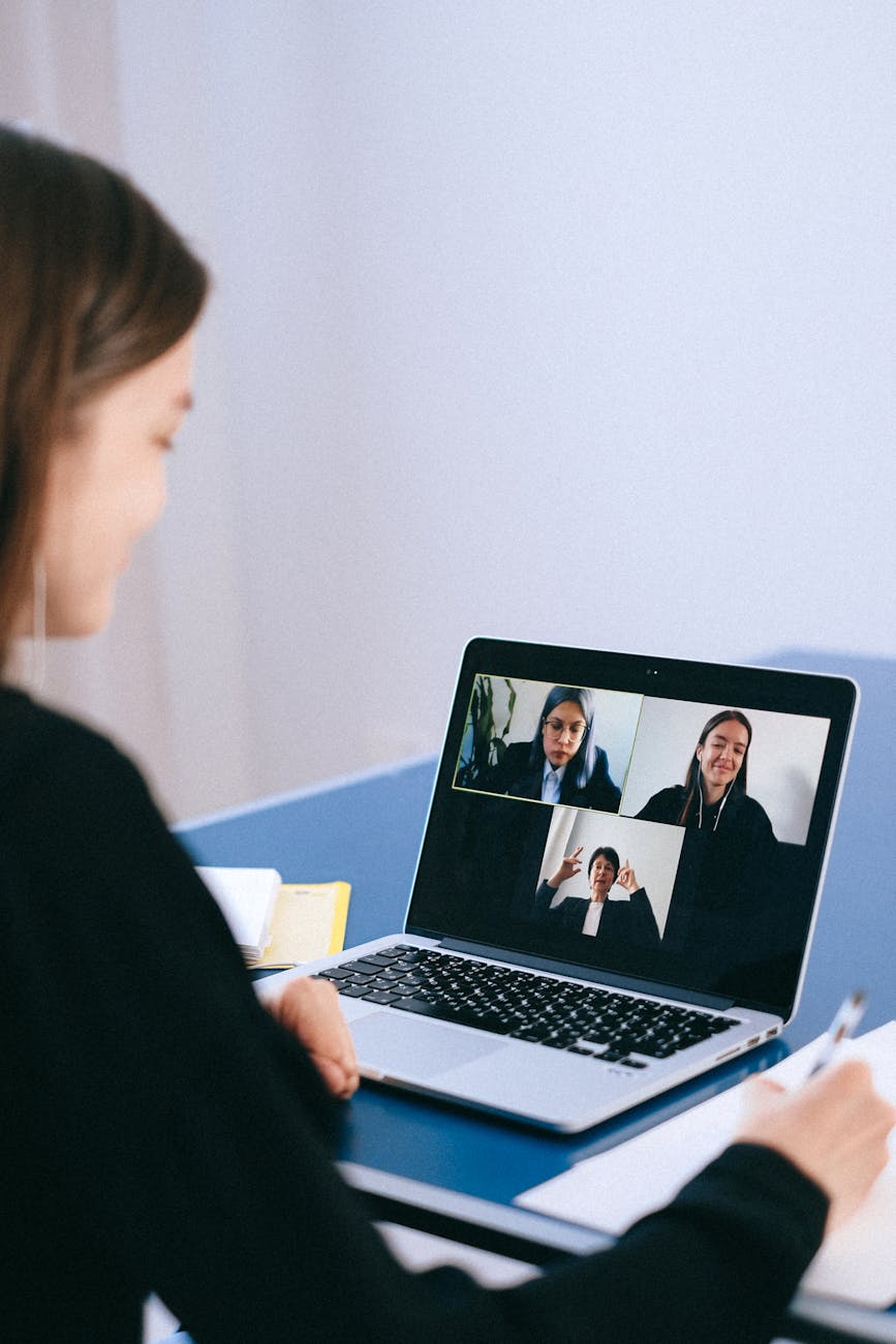 Diverse team of remote professionals on video conference call with multiple screens